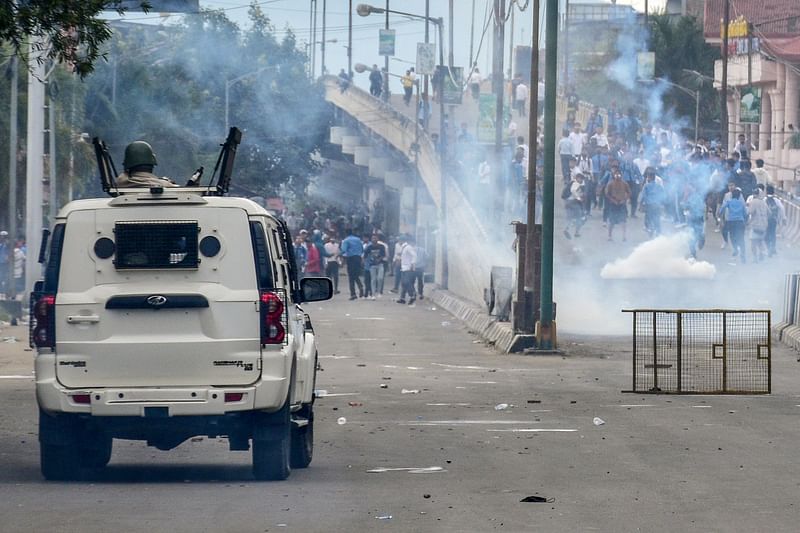 Security personnel fire tear gas shells to disperse protesters during a curfew in Imphal on 10 September 2024. India’s strife-torn northeastern state of Manipur ordered an internet blackout on September 10, after imposing a curfew following days of deadly ethnic violence and clashes between protesters and police